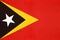 East Timor national fabric flag, textile background. Symbol of international asian world country