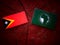 East Timorese flag with African Union flag on a tree stump isolated