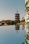 East and west towers of Kaiyuan Temple at dusk, with mirror reflection in foreground in Quanzhou