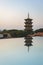 East and west towers of Kaiyuan Temple at dusk, with mirror reflection in foreground in Quanzhou