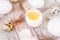 easter background with chicken quail one broken eggs and feathers on white wooden table, food top view