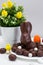 Easter background - close up of chocolate Easter bunny, colorful eggs and sweets