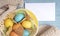 Easter background with colored eggs and cookies, empty white list