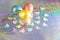 Easter background. Colored eggs of gold, pink, blue turquoise pearl color on a holographic rainbow background with a copy space