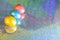 Easter background. Colored eggs of gold, pink, blue turquoise pearl color on a holographic rainbow background with a copy space