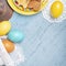 Easter background with colored eggs and holiday homemade cookies