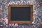 Easter background colorful crushed eggshell and blank chalkboard