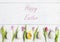 Easter background with Easter eggs, tulips and happy Easter sign