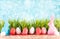 Easter background with eggs, rabbits and green grass