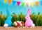 Easter background with eggs, rabbits and green grass