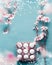 Easter background frame with spring blossom branches and egg-crate with Easter eggs and bokeh on blue, top view with copy space