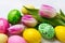 Easter background with green, yellow, pink painted eggs in the n