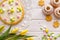 Easter background with marzipan eggs, mazurek pastry, yeast cakes, spring flowers