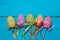 Easter background. Multicolored decorated easter eggs, multi-colored powder on a turquoise background. Free space