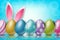Easter background with painted 3d realistic egg and bunny ears behind on blue backdrop with bokeh