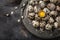 Easter background with quail eggs on grey plate, spring branch a