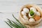 Easter background. In a sieve in the hay there are white chicken eggs, one egg in the center with sprouted herbs, one brown. A