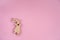 Easter background. Wooden bunnies on a pink background