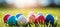 Easter banner with colorful eggs, sun rays, and copy space on blurred defocused background
