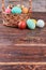 Easter basket, brown wood surface.