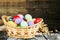Easter basket filled with colorful eggs on