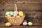 Easter basket filled eggs over rustic wood