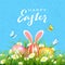 Easter Blue Background with Eggs in Grass and Rabbit Ears