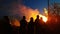 Easter bonfire with people outdoors standing next to fire