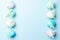 Easter border. Colorful egg with tape ribbon on pastel blue background in Happy Easter decoration. Flat lay, top view