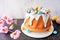 Easter bundt cake decorated colorful chocolate candy eggs.