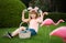 Easter bunny boy. Child in bunny ears hunting easter eggs outdoor on backyard. Cute child with easter basket on grass.