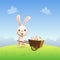 Easter bunny carrying cart with colorful decorated Easter eggs - spring landscape