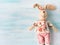 Easter bunny doll over turquoise pastel wooden backdrop