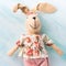 Easter bunny doll over turquoise pastel wooden backdrop