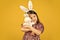 easter bunny kid. small girl hold hare toy. happy childhood. cute child play with toy. toy shop concept. girl in funny