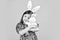 easter bunny kid. small girl hold hare toy. happy childhood. cute child play with toy. toy shop concept. girl in funny