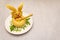 Easter bunny kids food concept. Warm pumpkin cream soup in fresh bun roll with herbs and pumpkin seeds in plate. Stone