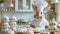 Easter bunny in the kitchen. The Easter bunny in a white chef\\\'s hat and a white apron stands at kitchen table with Easter