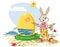 Easter bunny painting yellow red egg at the beach