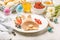 Easter bunny of pancakes with berries. Easter Breakfast table. Colored eggs, milk, juice and jam