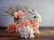 Easter Bunny Rabbit covered in peach flowers sitting on a wooden counter with a vase of peach flowers in the background and some