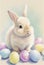 Easter bunny rabbit surrounded by colourful eggs with a pastel watercolour effect which is useful for a greeting card in spring,