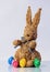 Easter bunny from straw with colored eggs