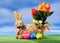 Easter bunny from straw with colored eggs and flower