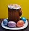 Easter cake and four painted eggs on a white plate