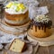 Easter cake kulich. Traditional Easter sweet bread decorated meringue, chocolate and yellow daffodils on wooden background with