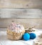 Easter cake on a light background, in a rustic style with blue eggs and beautiful sprigs of willow on a white napkin