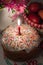 Easter cake with a lit candle on a celebratory table