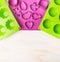 Easter cake mould with cookie cutter on white wooden background, top view, place