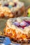 Easter cake on a wooden table and bronze paper. Nuts and oval sweet sweets in the form of eggs. Beautiful blurred background.